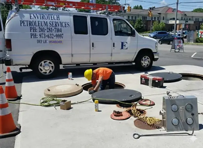 Certified Enviro-tech technician performing fuel system maintenance and testing following strict safety protocols and industry compliance standards.